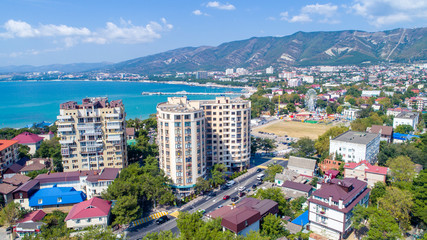 New multi-storey residential building on the shore of the beautiful Gelendzhik Bay. Black sea coast of the Caucasus, resorts of Kuban. Another residential complex is being built nearby. In the backgro