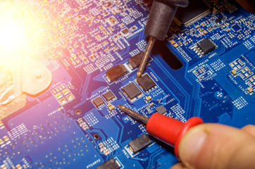 colorful electronic board and tools repairs on old laptop, vibrant concept