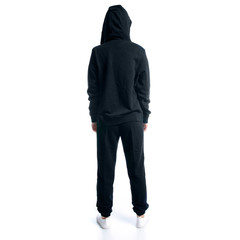 Woman in black tracksuit hood standing on white background isolation, back view