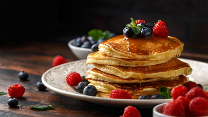 Homemade american pancakes with fresh blueberry, raspberries and honey. Healthy morning breakfast. rustic style