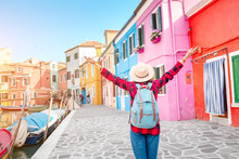 Happy Asian Traveler Woman Having Fun On Well Known Burano Island Near Venice. Travel And Vacation In Italy Concept