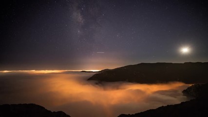 Wall Mural - night time lapse of a road winding through the mountains in malibu california.