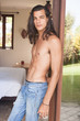 © Dana Keli - attractive handsome young man with long dark hair and a naked torso standing in the doorway.