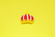 Leinwandbild Motiv Ginger cookies in the shape of a crown on a yellow background. Small gifts, souvenirs, postcards. Minimal fashion Still life.