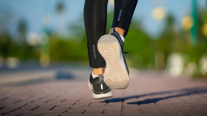 Wall Mural - Young woman runner running on city bridge road, Young fitness woman runner athlete running at road 