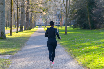 Fit young woman jogging in a park