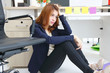 © tuaindeed - Stressed tired young Asian business woman sitting on floor and feeling depression in workplace of office.
