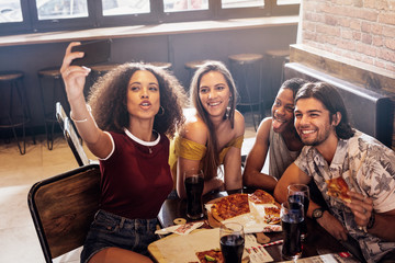 Wall Mural - Group of friends making a selfie at restaurant