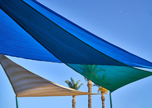 Multicolored Fabric Awning From The Sun Above The Children's Pool