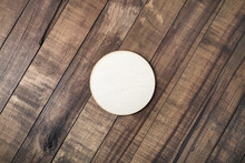 Blank Wooden Beer Coaster On Wood Table Background. Flat Lay.