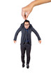 © Creativa Images - Young businessman lifted by big hand on studio