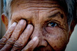 Old women cover her eye with her hand for eye testing use for medical and healthcare background