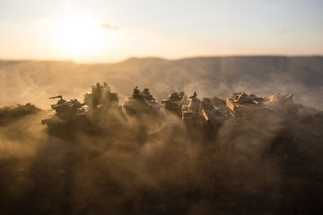 Wall Mural - War Concept. Military silhouettes fighting scene on war fog sky background, World War Soldiers Silhouettes Below Cloudy Skyline at sunset. Attack scene. Armored vehicles.