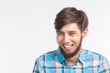 Laughing bearded handsome man on white background with copy space