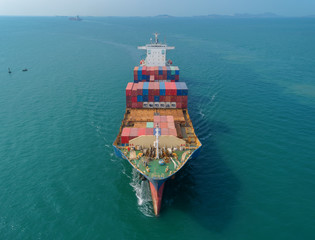 Aerial front view container ship going to sea port for load container. Logistic business, import export, shipping or transportation.