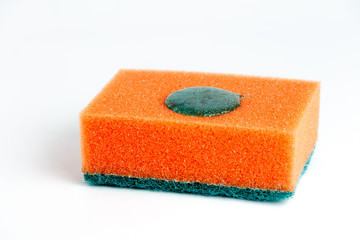 Sponge for washing dishes on a white background with a drop of detergent.