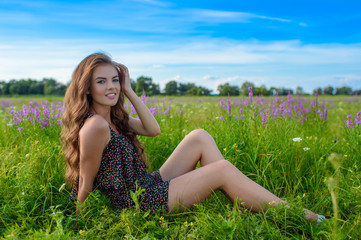 Model posing in a field of white lavendar flowers.