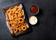 Curly Fries Fast Food Snack In Wooden With Ketchup On Stone Kitchen Background. Unhealthy Junk Food