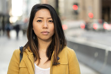 Young Asian Woman In City Serious Face Portrait