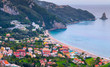 Beautiful summer panoramic seascape. View of Agios Gordios famous beach in rocky bay with crystal clear azure water on Corfu island, Ionian archipelago, Greece.