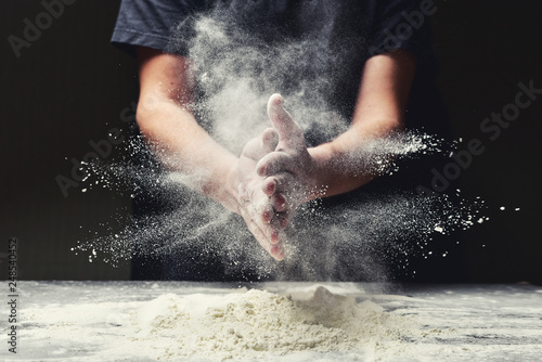 Fotografía Clap hands of baker with flour in restaurant kitchen