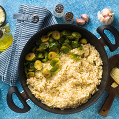 Wall Mural - Italian spring risotto with Brussels sprouts and parmesan cheese on the table. healthy food for the whole family, party or restaurant menu