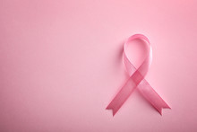 Pink Ribbon On Color Background, Top View With Space For Text. Breast Cancer Awareness Concept