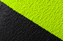 Black And Phosphorus Green Diagonal Strip Caution Sign On The Wall. Striped Black And Green Paint Wall Texture. The Background For Printing, Wallpapers Or