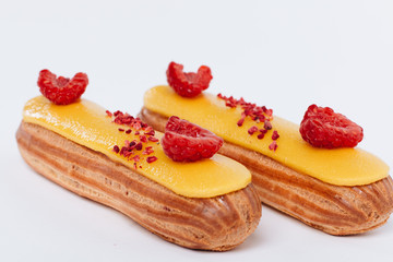 Wall Mural - Delicious eclairs with yellow glaze, sweet dessert