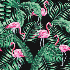 Wall Mural - Green tropical leaves and pink flamingo seamless pattern black background