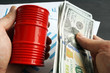 © Vitalii Vodolazskyi - Hands are holding barrel and money. Oil trading.