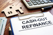 Cash out refinance documents and model of house.