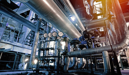 Equipment, cables and piping as found inside of a modern industrial power plant