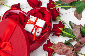 Wall Mural - St. Valentines Day. Red roses and gift box on wooden table