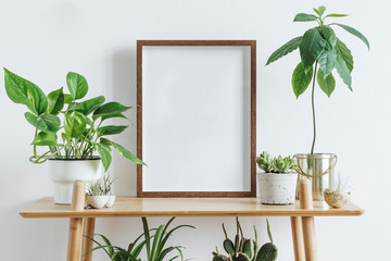 scandinavian room interior with mock up photo frame on the brown bamboo shelf with beautiful plants 