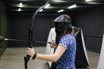 Girl with crossbow arrows bow. The Archer takes aim, sharpshooter. Crossbow club.