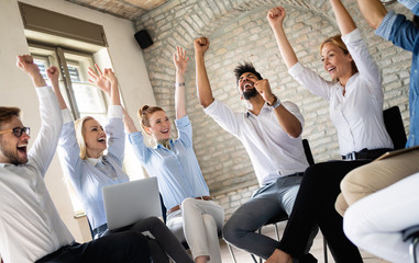 Business team celebrating a good job in the office