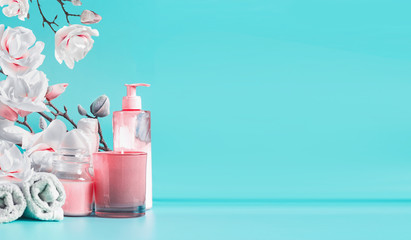 Wall Mural - spa beauty background with tools and cosmetics : cream, towels, burning candles on pastel blue table