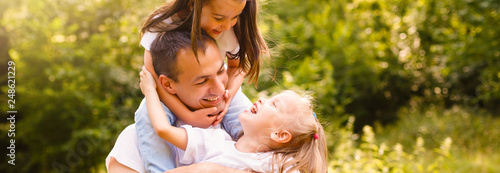 Happy father and little daughters spending time Tableau sur Toile