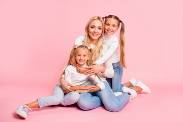 Wall Mural - Portrait of nice-looking cute attractive charming cheerful cheery stylish people mom mum sitting cuddling spending free time isolated over pink pastel background