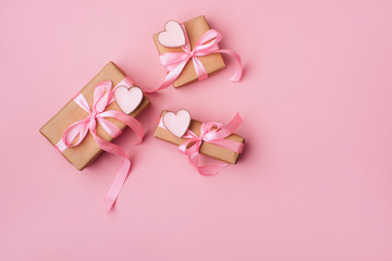 Wall Mural - Valentine day composition: white gift boxes with bow and pink hearts. Top View. View from above.