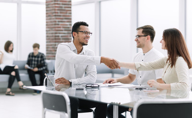 Wall Mural - handshake of business people in the lobby of the modern business center.