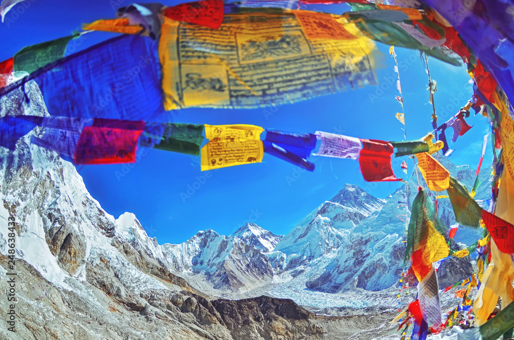 View of Mount Everest and Nuptse  with buddhist prayer flags from kala patthar in Sagarmatha National Park in the Nepal Himalaya - obrazy, fototapety, plakaty 