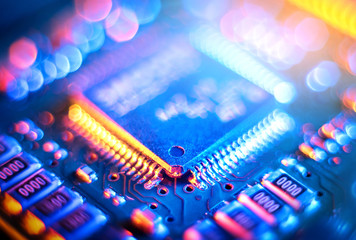 Wall Mural - Computer Microchips and Processors on Electronic circuit board. Abstract technology microelectronics concept background. Macro shot, shallow focus.