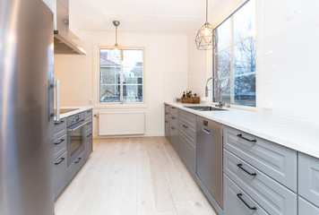 strylich kitchen interior with grey interior and windows