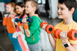 © LIGHTFIELD STUDIOS - Cute children training with colorful dumbbells