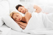 © Syda Productions - people, rest and relationships concept - happy couple sleeping in bed at home