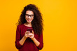 © deagreez - Portrait of her she nice lovely attractive pretty cheerful cheery wavy-haired lady holding in hands cell playing game free time isolated over bright vivid shine orange background