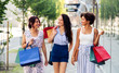 © Syda Productions - sale, consumerism and people concept - happy young women with shopping bags walking along city street