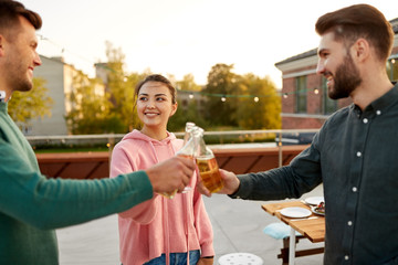 Canvas Print - leisure and people concept - happy friends toasting non alcoholic drinks at barbecue party on rooftop in summer